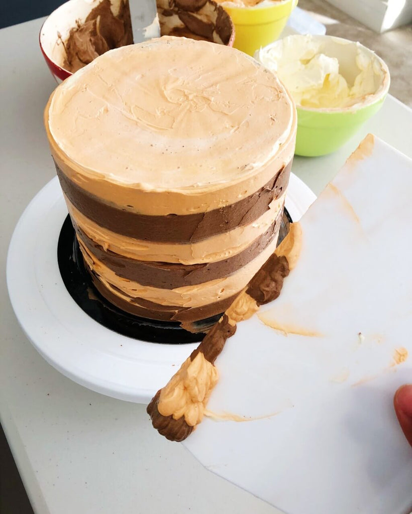 Chocolate Orange Drip Cake Recipe - excess buttercream scraped