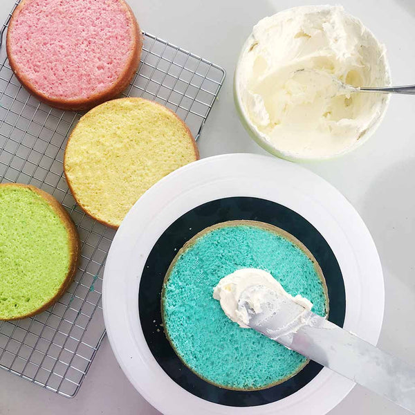Rainbow Cake Recipe - sandwiching rainbow layers