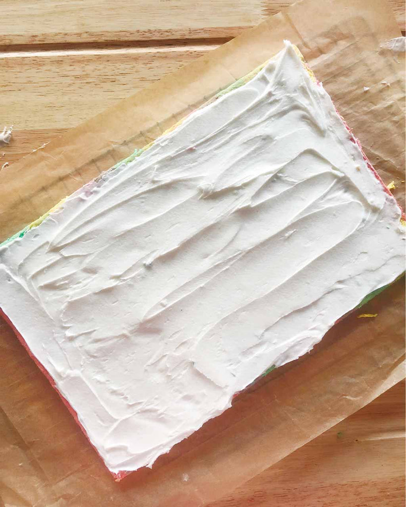Rainbow Cake Roll Recipe - spread buttercream