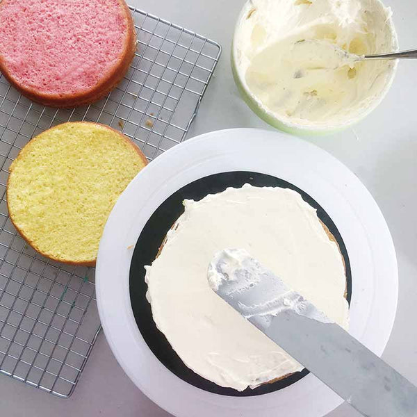 Rainbow cake recipe - layering sponges and buttercream