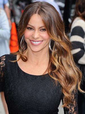 Smiling Sofia Vergera with long curly brown hair