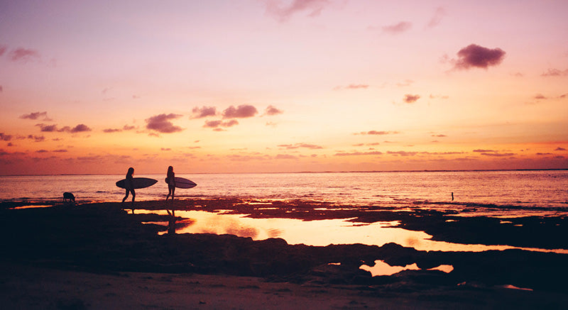 Girls after a surf in magic sunset in Bali