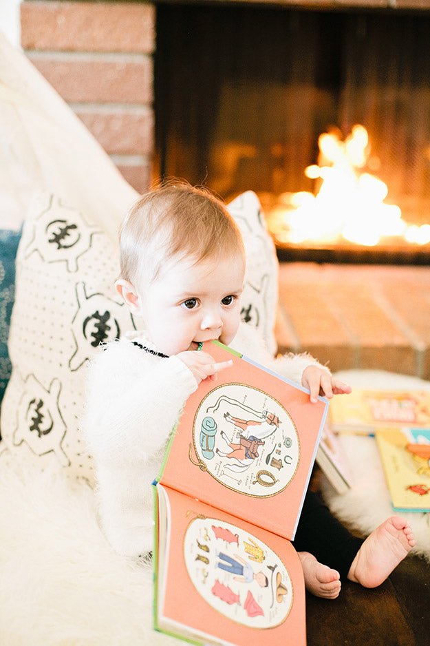 Baby playing near a cozy fire