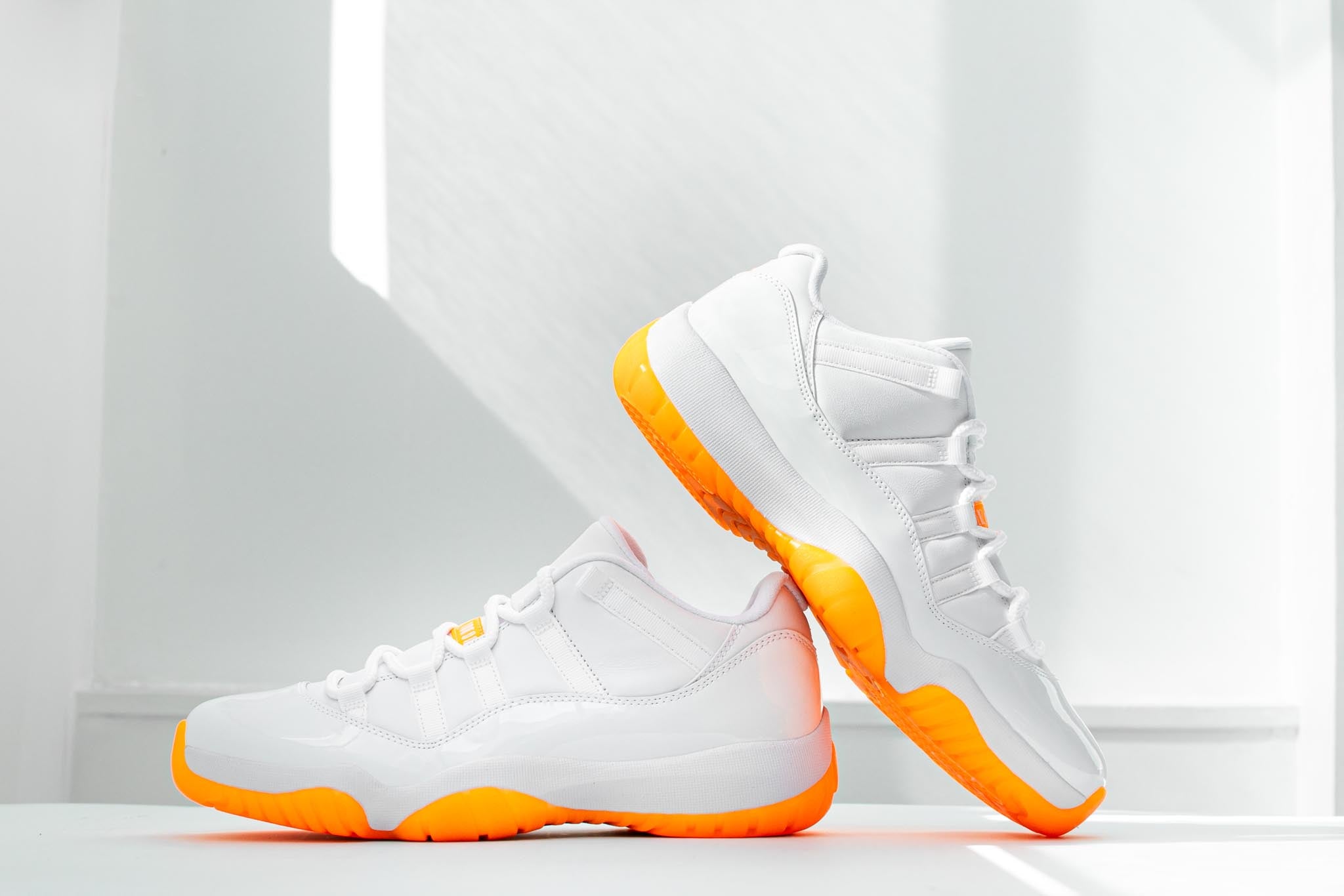 jordans 11 white and orange