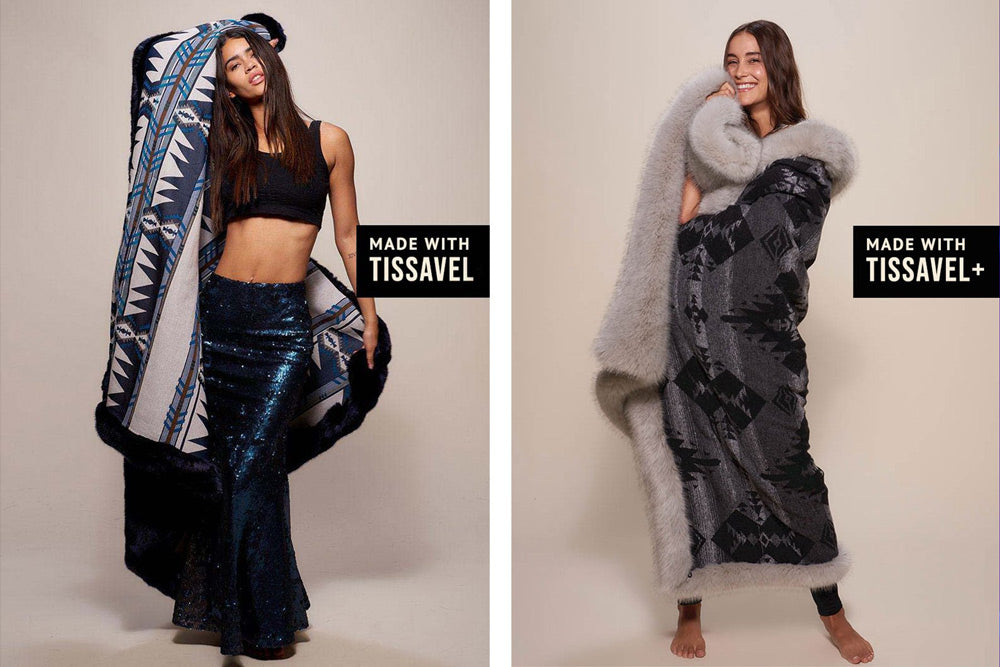 two women holding tissavel faux fur throw