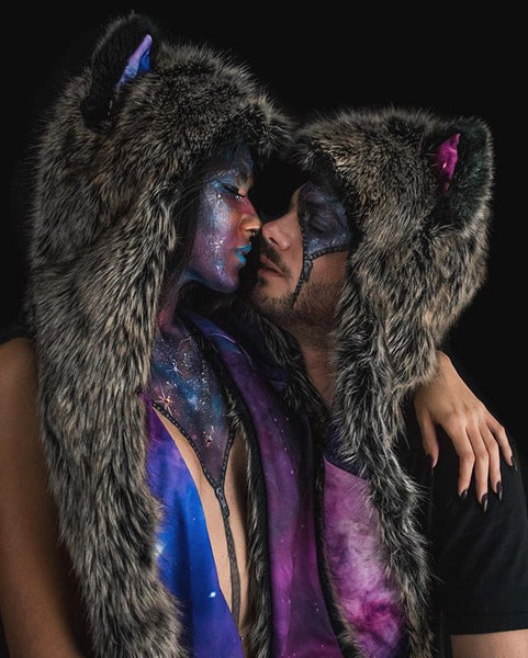 two people with face makeup wearing faux fur hoods with galaxy makeup