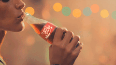 women drinking a bottle of coke
