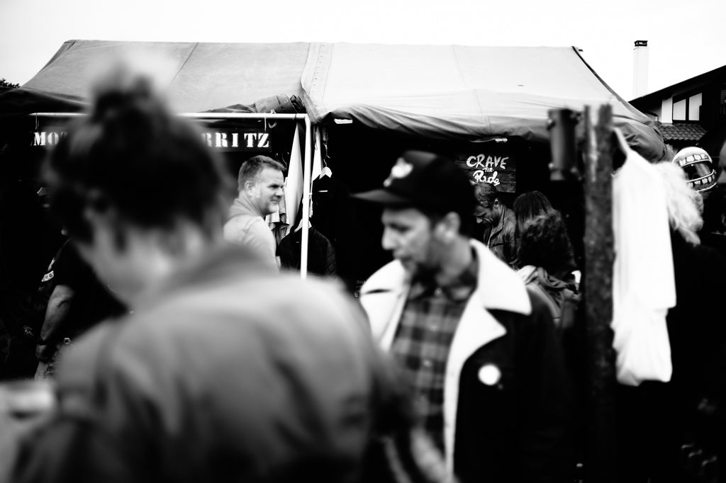 Crave for Ride tent sign as seen from behind the crowd at Wheels and Waves Festival 2015