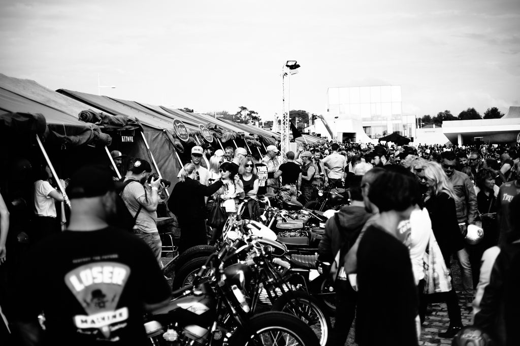 Crowd watching custom motorcycles taking photos chatting at Wheels and Waves Festival 2015