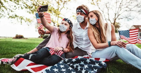 American family taking a picture with masks on.
