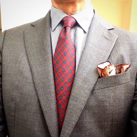 Grey jacket with red tie and pocket square