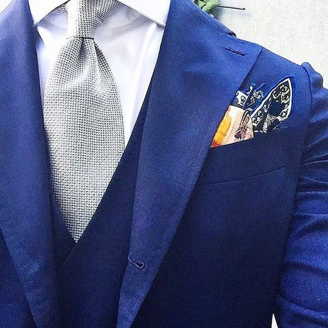 Grey tie with blue pocket square