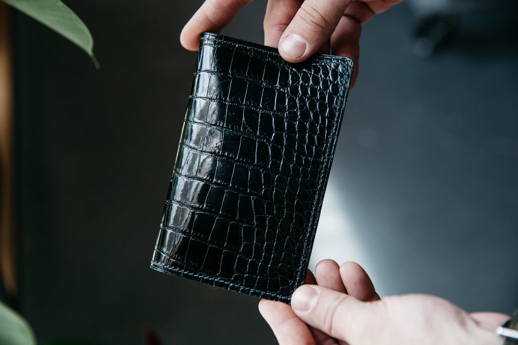 handmade glazed black alligator skin passport and journal wallet with french chevré interior. handstitched luxury wallet