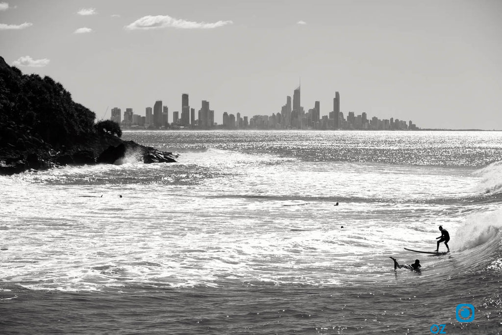 Black and white photo of people surfing at Burleigh Head