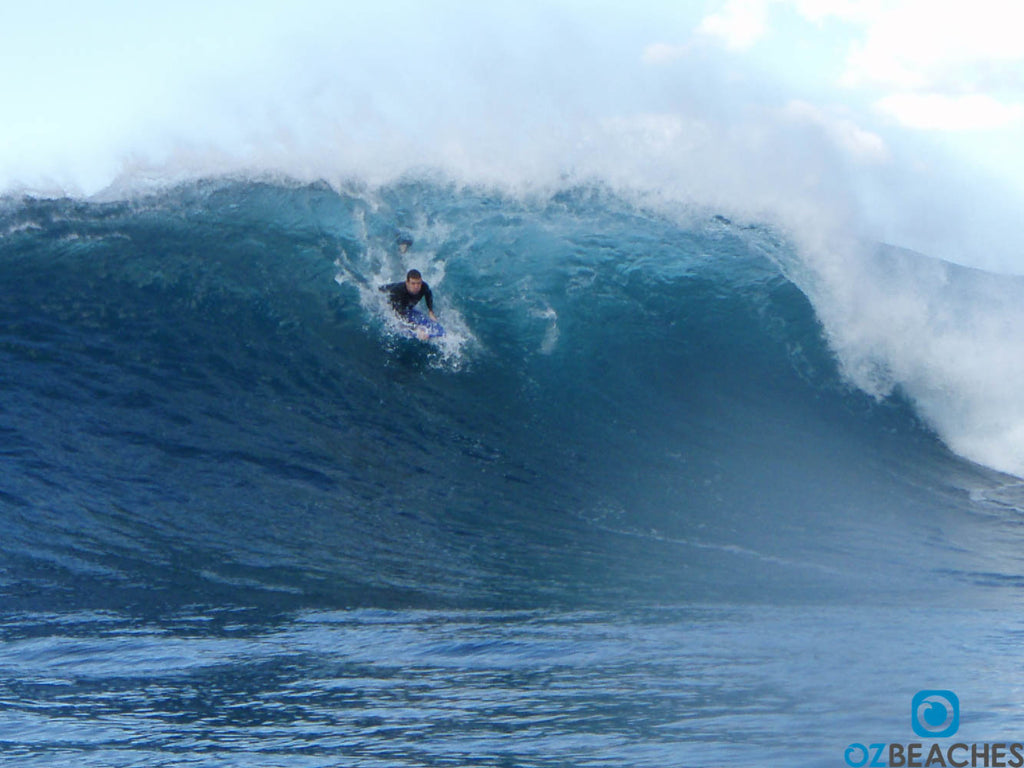 Bodyboarder dropping in on a large wave at Lurline Bay