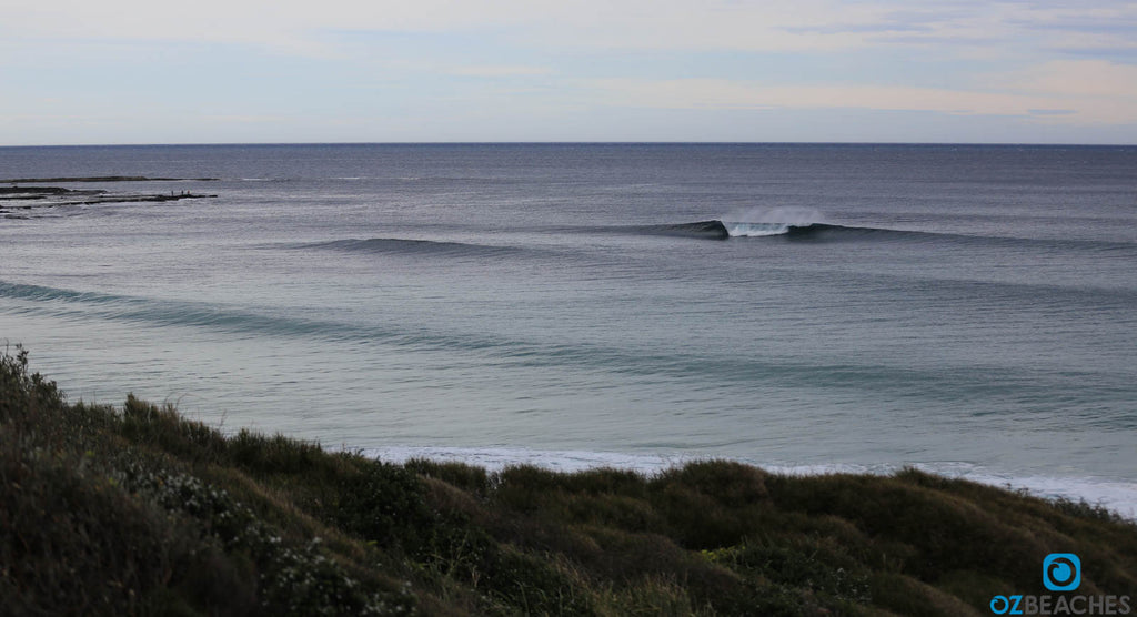 Sleek swell lines rolling into The Bommie at Ulladulla NSW on a smooth day