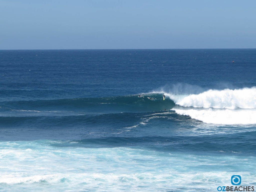 Surfer dropping into a bomb wave at The Bommie, Ulladulla NSW