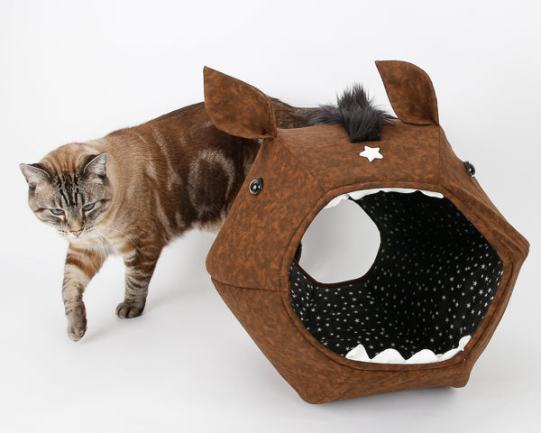 A cat walking around the novelty horse Cat Ball cat bed