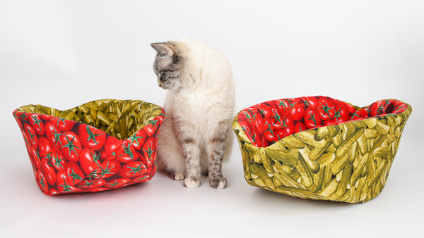 Pair of coordinating Cat Canoe® beds made with funny tomatoes/pickles fabrics