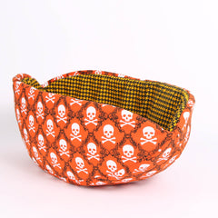 The Cat Canoe is a modern pet bed in skull and crossbones fabric for Halloween