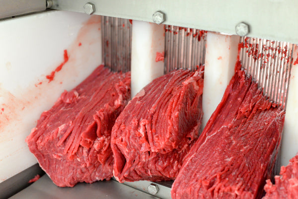 Slicing meat in our beef jerky factory.