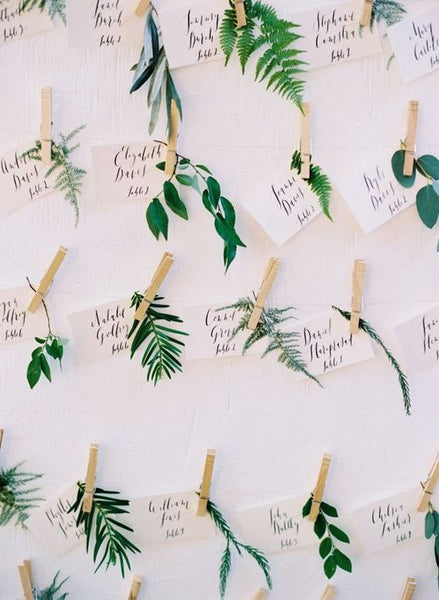 Hanging your escort cards by using strings and clothespin is the rustic way to go.