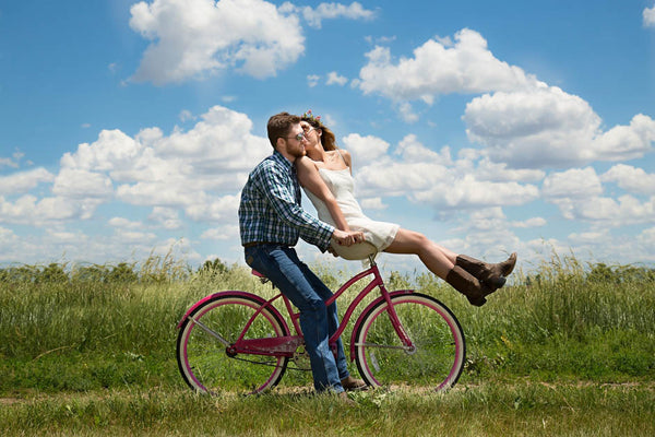 engaged couple on bike 