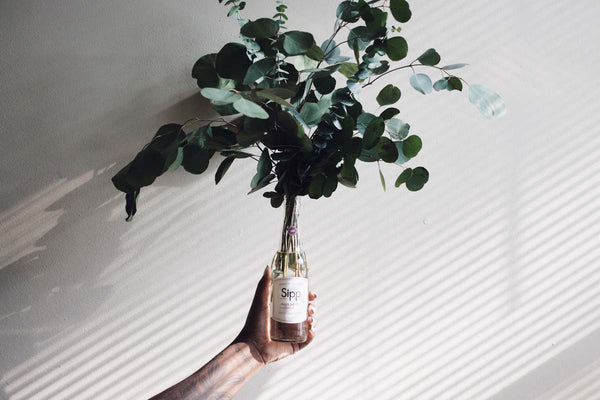 wine bottle with plant centerpiece