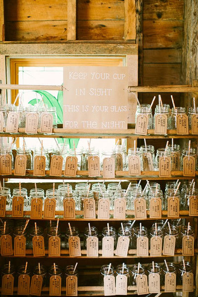 Mason jars with escort cards serve a dual purpose. Aside from letting your guests know where they should be seated, you can also use the jars for their beverage for the night.
