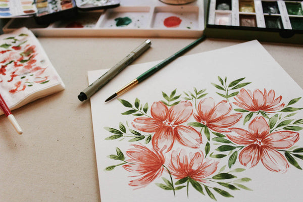 watercolor paintings on desk