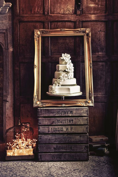 Frame your wedding cake literally by using a large wooden frame as a decoration