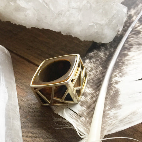 Lattice Square Cocktail Ring in Tiger's Eye on wood table next to crystals and feather