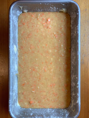 Carrot pineapple cake batter in rectangular loaf pan.