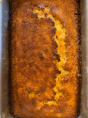 Baked carrot pineapple cake in rectangular metal loaf pan.