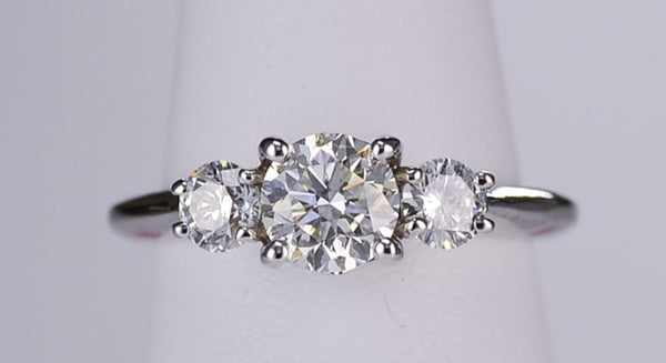 Three stone engagement ring with a one carat center stone