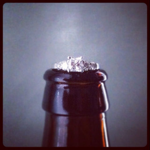Engagement ring on beer bottle