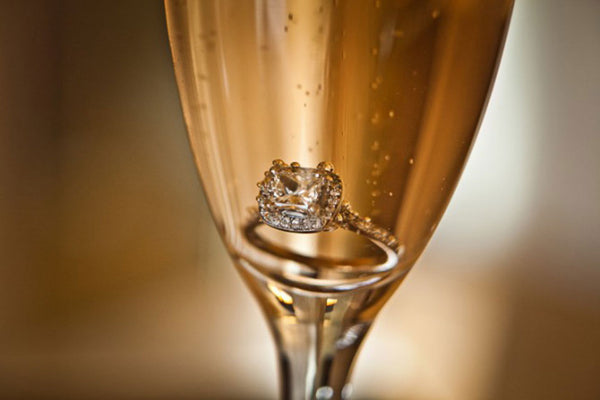 Engagement ring hidden in champagne glass 