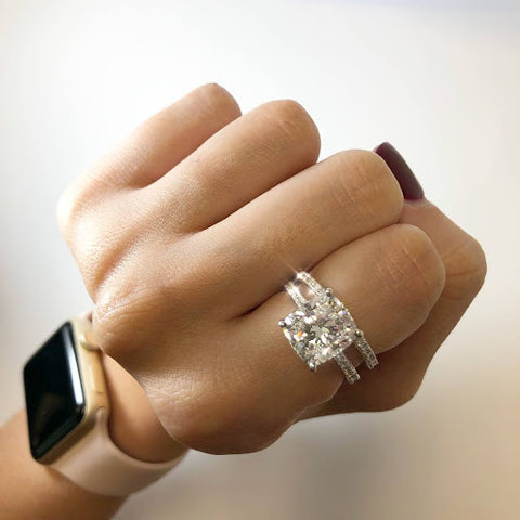 cushion cut engagement ring on hand