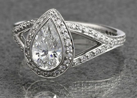 Vintage split shank pear diamond ring with halo