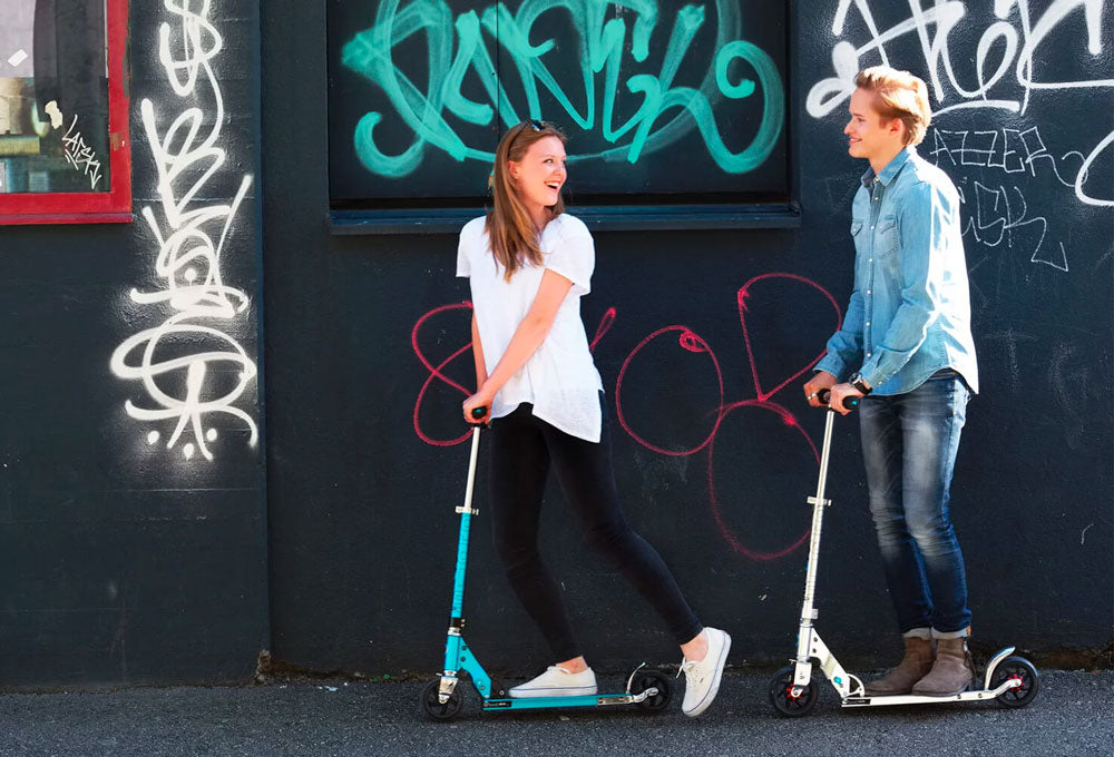 girl riding Micro Rocket kick scooter with extra wide wheels