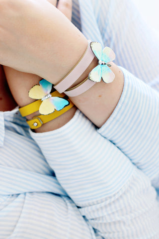 Butterfly brooch worn with a vegan leather wristband