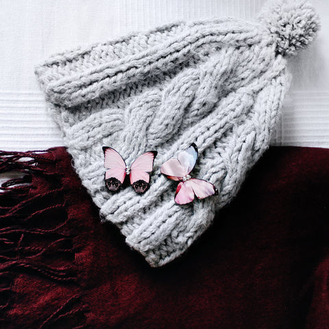 Butterfly Brooches Pinned to a Bobble Hat.