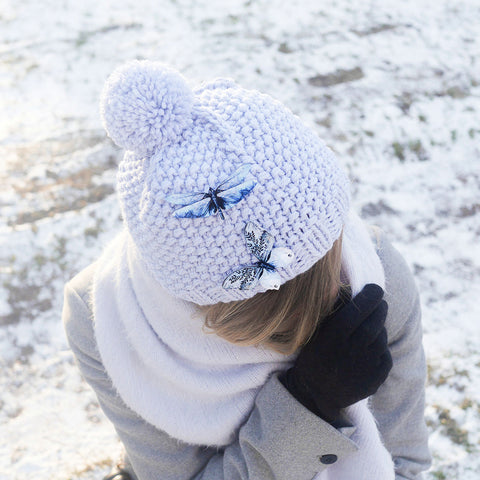 Butterfly brooches pinned to a winter wollen hat.