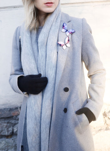 Kuma Butterfly Brooches worn on a coat.