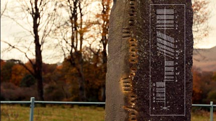 Ogham standing stone with example of Ogham writing
