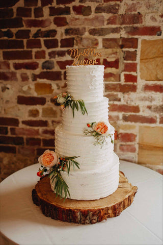 Buttercream covered wedding cake with fresh flowers