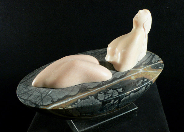 Land a figure in marble on a Picasso marble ellipital base sculpture