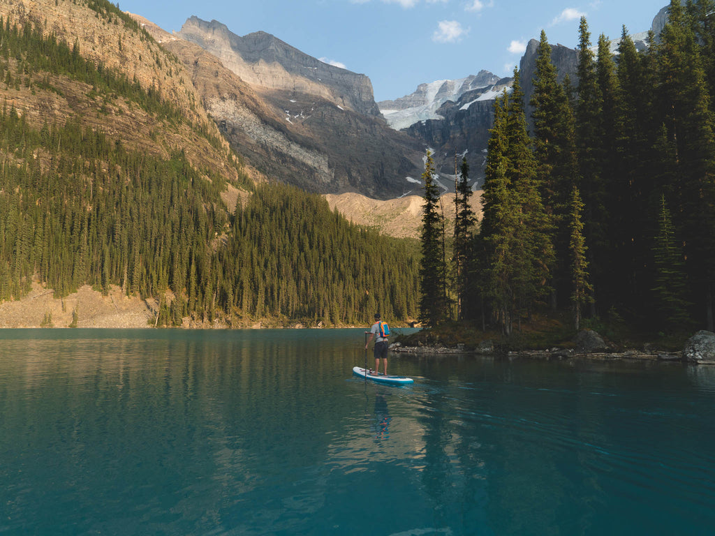 man in mountains on SUP