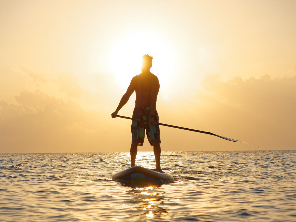 Paddling at sunset on a performance SUP board