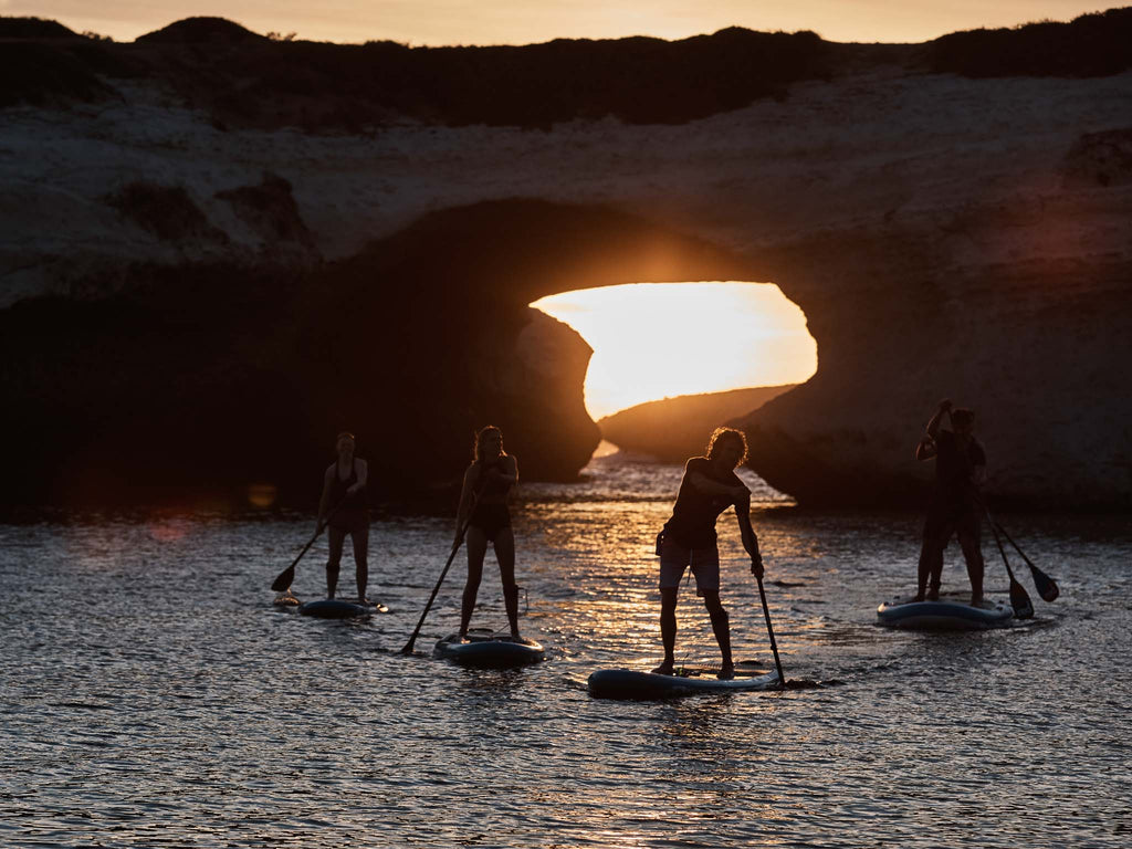 Paddlers at sunset on all around boards